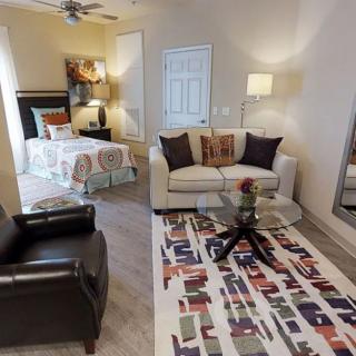 A cozy open-concept living and bedroom space with modern decor.