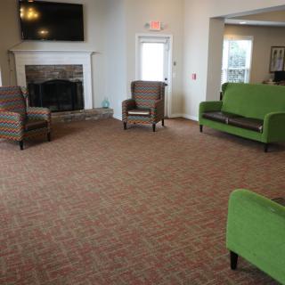 A cozy living room with a fireplace, television, and comfortable seating.