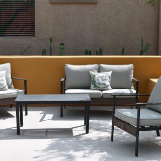 A cozy outdoor patio setup with cushioned chairs and a small table.