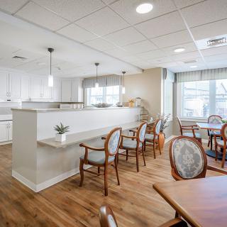 A bright and airy dining space with elegant seating and wooden flooring.
