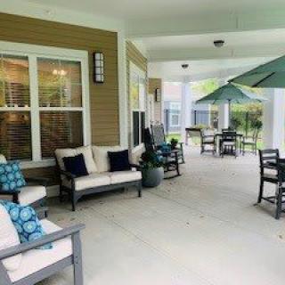 A cozy outdoor patio area with comfortable seating and umbrellas.