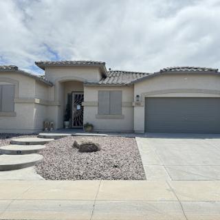 A contemporary single-family home with a landscaped front yard.