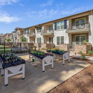 Apartment complex with outdoor garden planters.