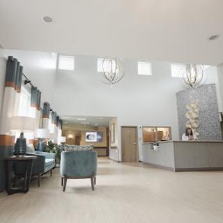 A spacious and modern hotel lobby featuring stylish furniture and elegant lighting.