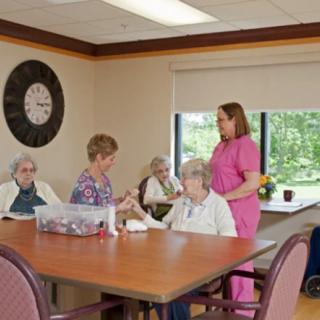 Caregivers assisting elderly residents in a nursing home setting.