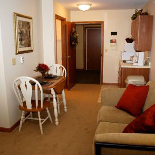 A cozy apartment living room with a dining area and comfortable furniture.
