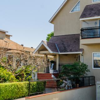 A cozy residential house with a small garden and balcony.