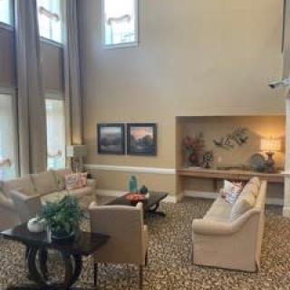 A spacious living room with elegant furniture and modern decor.