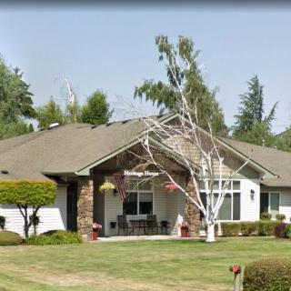 A suburban home with a well-maintained lawn and trees.