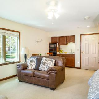 A cozy living space with a leather sofa and a compact kitchenette.