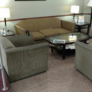 A cozy living room setup featuring a sofa, two armchairs, and a coffee table.
