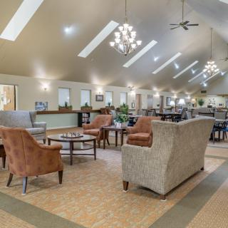 A spacious and modern lounge area with comfortable seating and elegant lighting.