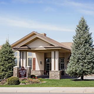 A small office building surrounded by trees and greenery.