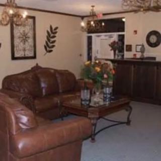 A cozy living room with leather sofas and elegant decor.