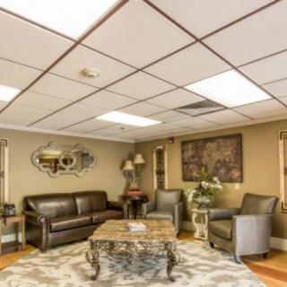 A cozy living room with comfortable seating and decorative elements.