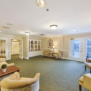 A cozy, brightly lit living room with comfortable seating and tasteful decor.