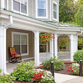 A charming house with a welcoming porch and vibrant garden.