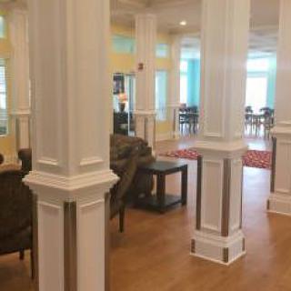 A spacious lobby area with elegant columns and comfortable seating.