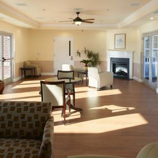 A cozy living room with comfortable seating, a fireplace, and abundant natural light.