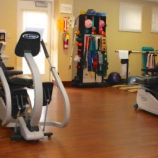 A well-equipped gym with various exercise machines and accessories.
