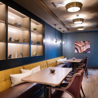 A cozy and modern dining area with stylish furniture and decorative lighting.