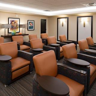 A comfortable lounge area with multiple chairs and ambient lighting.