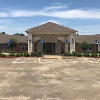 A modern building with a welcoming front entrance and accessible parking.