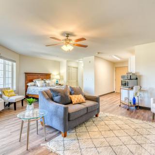 A modern and cozy bedroom with a living area featuring stylish furniture and abundant natural light.