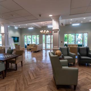 A modern and spacious lounge area with comfortable seating, natural lighting, and elegant interior design.