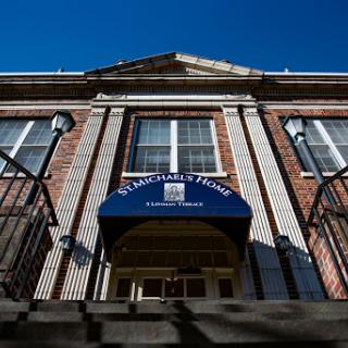 A view of the entrance to a brick building under a clear blue sky.