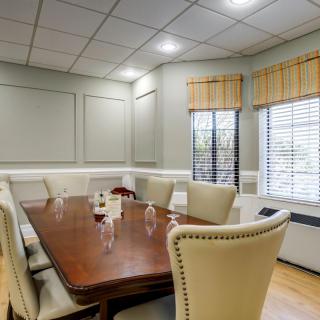 A well-furnished conference room with a large table and comfortable chairs.