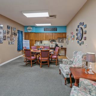 A cozy living space with a dining table, kitchen area, and comfortable seating.