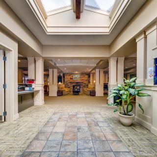 Spacious hallway with skylight and decorative columns.