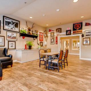 A cozy living room decorated with various framed artworks and comfortable seating.