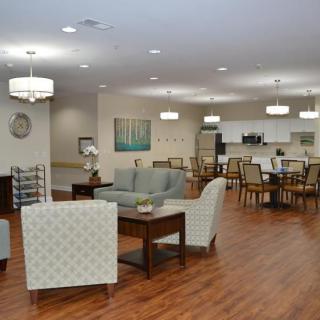 A modern, spacious living and dining area with comfortable seating and elegant lighting.