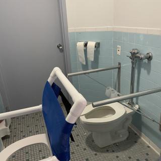 Accessible bathroom with grab bars and wheelchair accessibility.