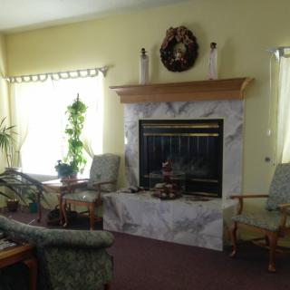 A cozy living room with a fireplace and comfortable seating.