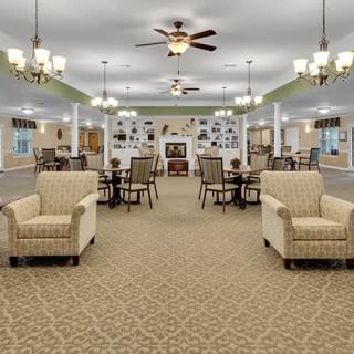 Spacious and elegantly designed living area with ample seating and chandeliers.
