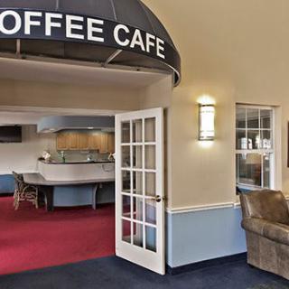 An inviting entrance to a cozy cafe with open doors and comfortable seating.