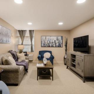 A cozy living room featuring comfortable seating, a television, and tasteful decor.