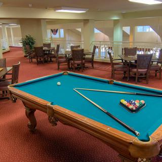 A recreational game room featuring a pool table and seating area.