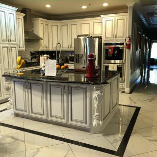 A luxurious modern kitchen with white cabinets and a central island.