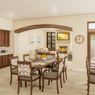 A modern dining room with elegant furniture and a kitchen area in the background.