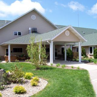 A lovely residential building surrounded by well-maintained landscaping.