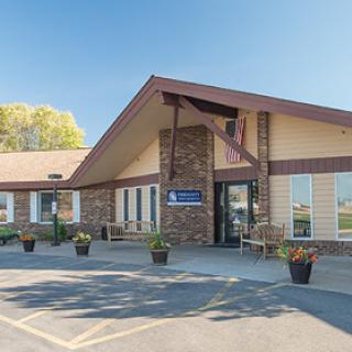 A welcoming building featuring a well-designed entrance and decorative flower pots.