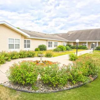 A scenic view of a residential building with a landscaped garden and pathway.