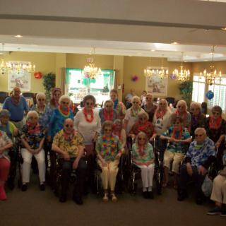 A group of seniors gathered indoors for a community event.