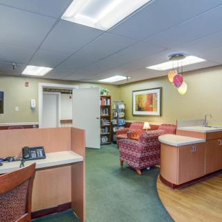 An inviting office reception area with comfortable seating and warm lighting.