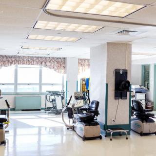 A bright and clean medical clinic with chairs and equipment arranged neatly.