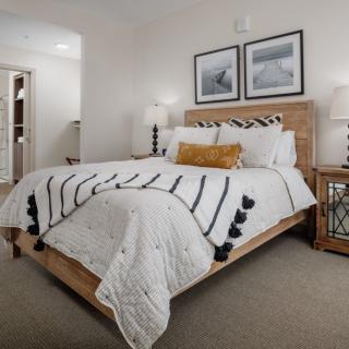 A stylish bedroom with a neatly made bed and elegant decor.